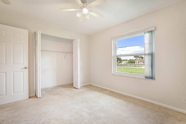 unfurnished bedroom featuring carpet floors, a ceiling fan, baseboards, and a closet