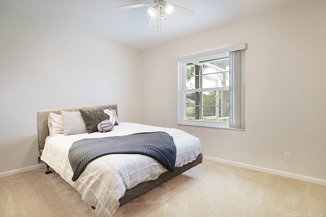 bedroom with carpet floors, ceiling fan, and baseboards