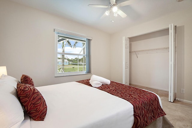 carpeted bedroom featuring ceiling fan and a closet