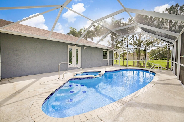 view of swimming pool featuring glass enclosure, french doors, a patio area, and a pool with connected hot tub