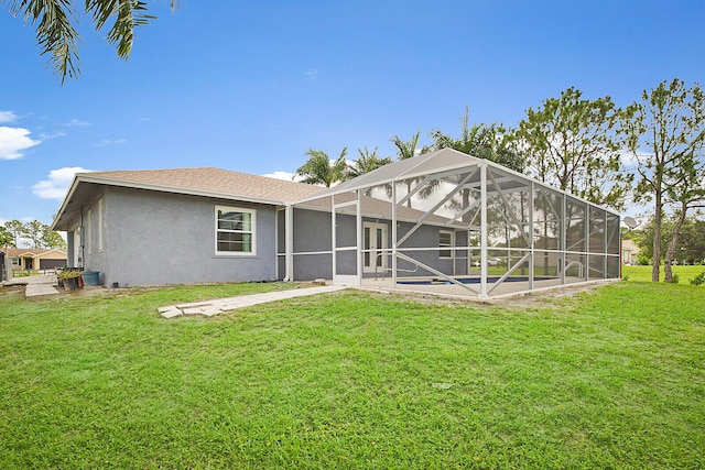 rear view of house featuring a yard and a lanai