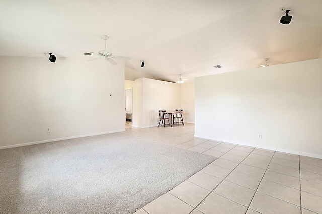 tiled spare room featuring ceiling fan