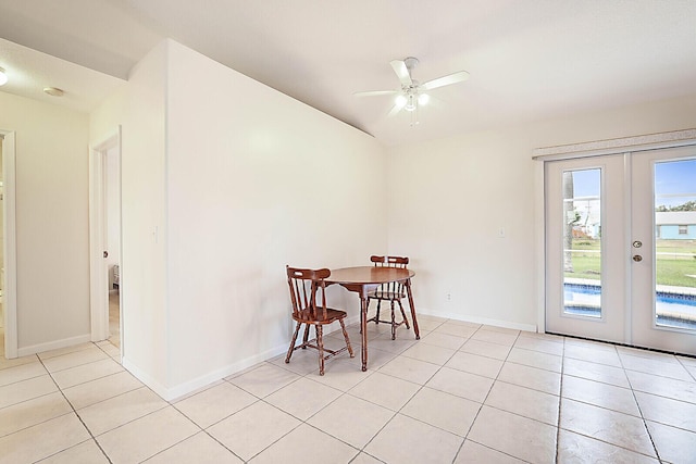 tiled dining area with ceiling fan and french doors