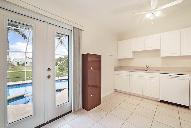 kitchen featuring white dishwasher, ceiling fan, sink, light tile patterned floors, and white cabinetry