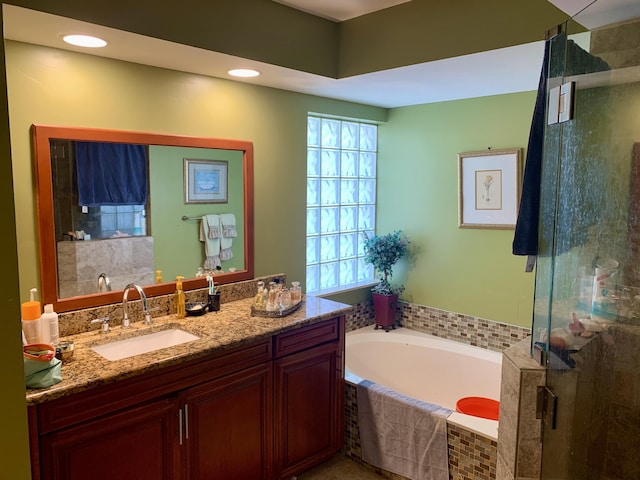 bathroom with plus walk in shower and vanity