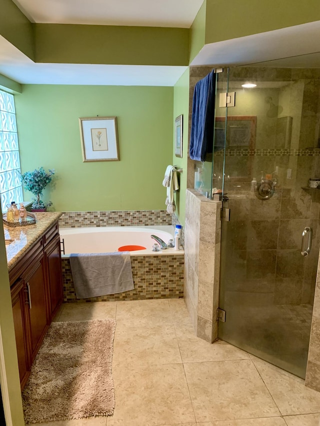 bathroom featuring tile patterned flooring, vanity, and independent shower and bath