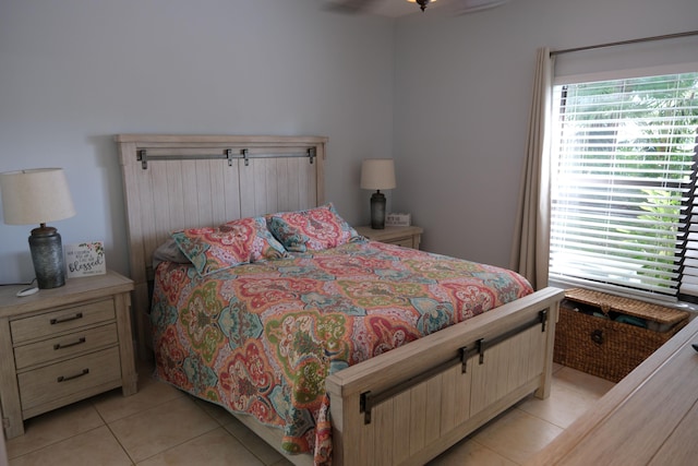 tiled bedroom featuring ceiling fan