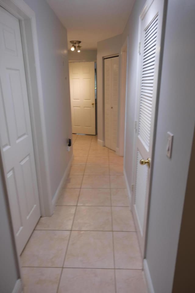 corridor featuring light tile patterned floors