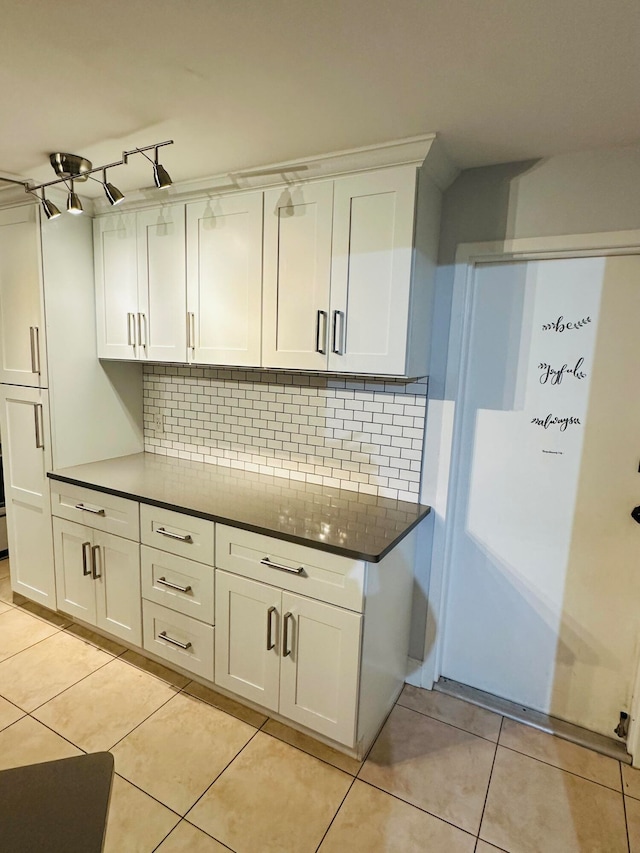 kitchen featuring white cabinets and backsplash