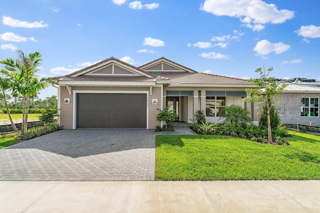 single story home with a garage and a front yard