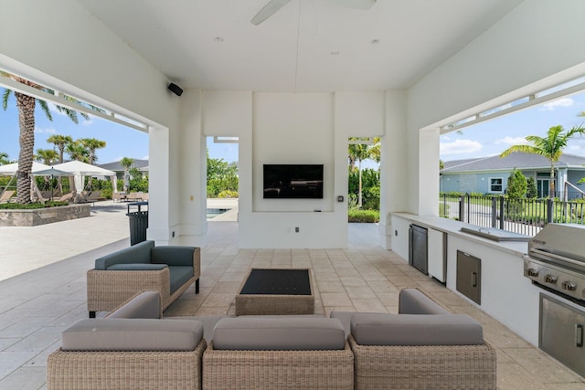 view of patio with outdoor lounge area, ceiling fan, area for grilling, and exterior kitchen