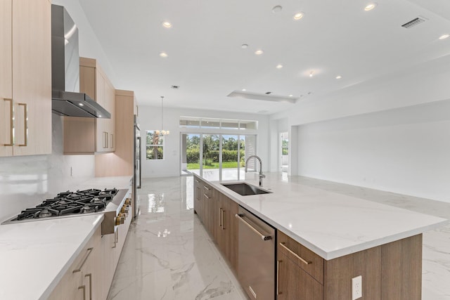 kitchen with stainless steel appliances, sink, hanging light fixtures, light tile patterned floors, and wall chimney exhaust hood