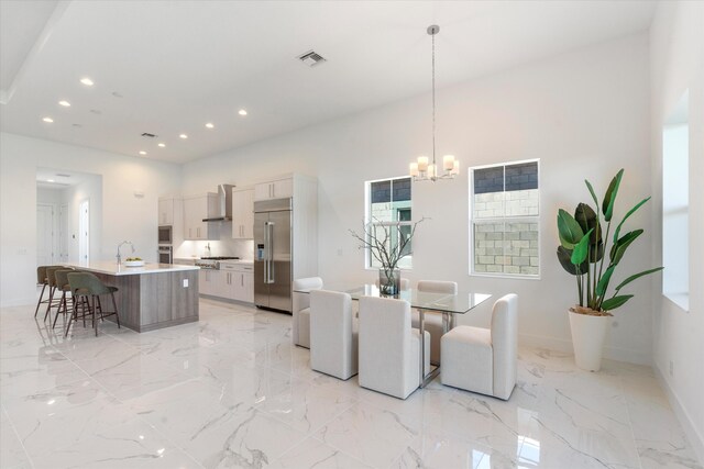 spare room with sink, light tile patterned floors, and a raised ceiling