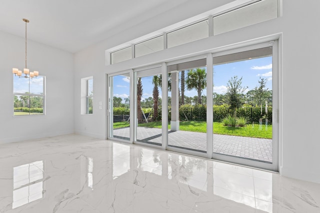 empty room featuring light tile patterned floors, plenty of natural light, and a chandelier