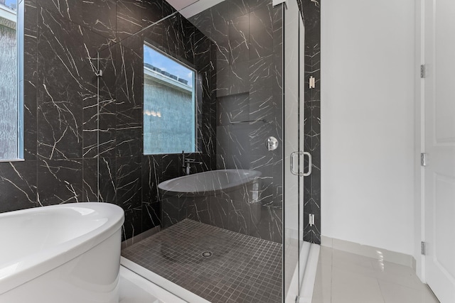 bathroom featuring an enclosed shower, tile walls, and tile patterned floors