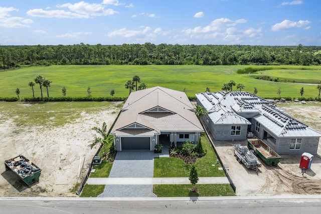 birds eye view of property featuring a view of trees