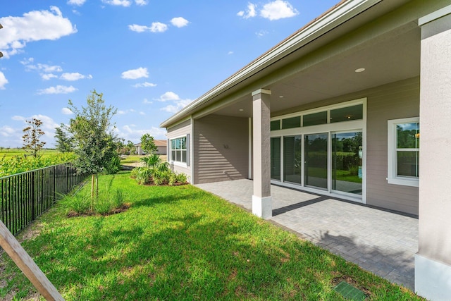 view of yard with fence and a patio