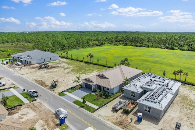 birds eye view of property with a wooded view