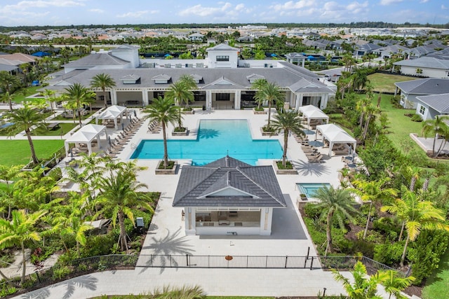 pool featuring a residential view, a patio area, and fence