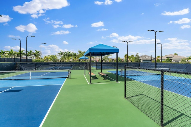 view of tennis court featuring fence