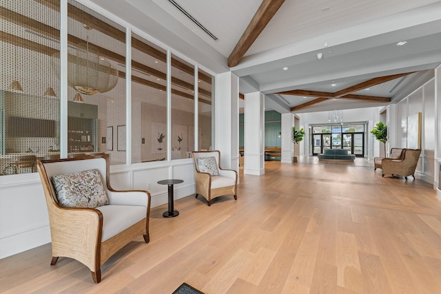 sitting room featuring light hardwood / wood-style floors and beam ceiling