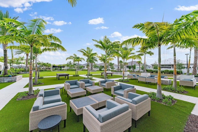 view of home's community featuring a lawn and an outdoor hangout area