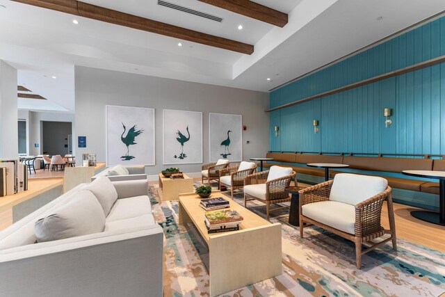 interior space with built in shelves, light hardwood / wood-style flooring, and decorative light fixtures