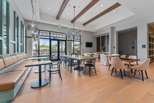 dining area featuring light wood finished floors, beam ceiling, a high ceiling, and recessed lighting