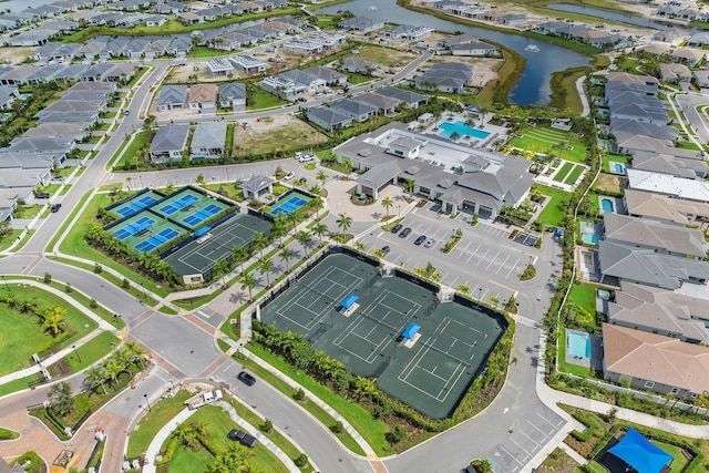 drone / aerial view featuring a water view and a residential view