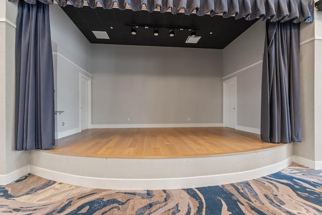 spare room featuring baseboards and wood finished floors