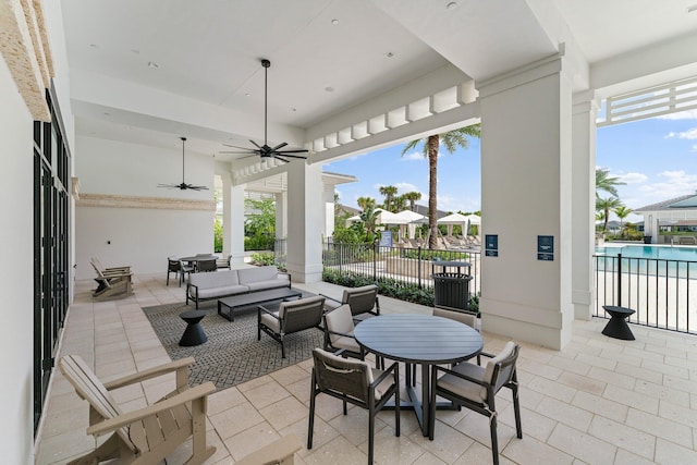 view of patio featuring a community pool, outdoor lounge area, and ceiling fan