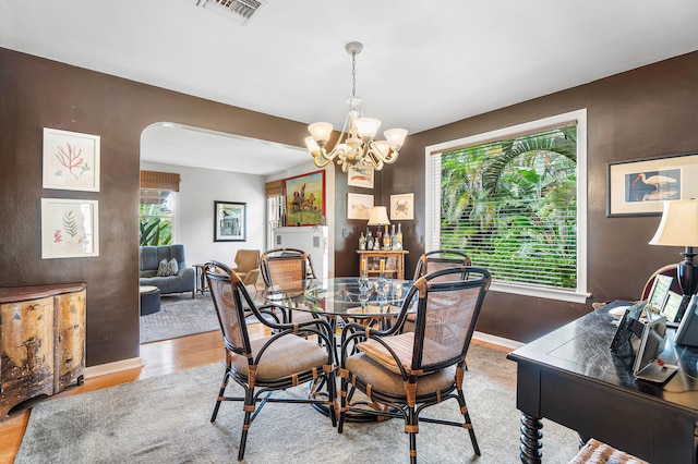 dining area with a chandelier and hardwood / wood-style flooring