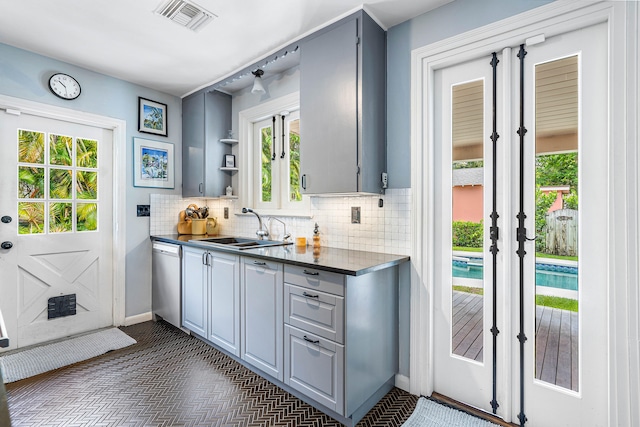 kitchen featuring sink, dark tile flooring, dishwasher, and gray cabinets