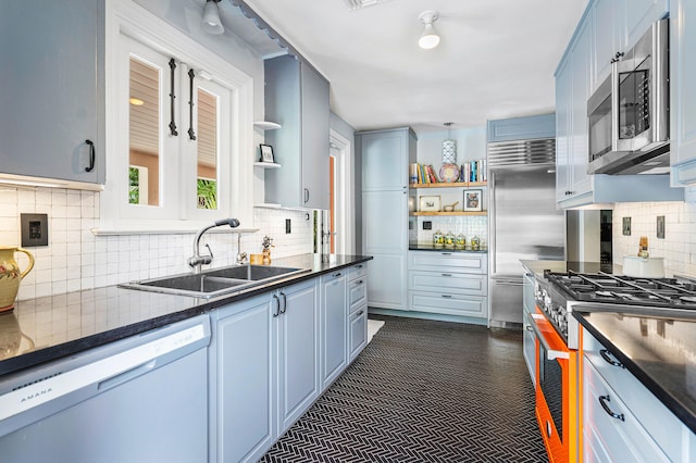 kitchen with gas range, dishwasher, tasteful backsplash, and sink