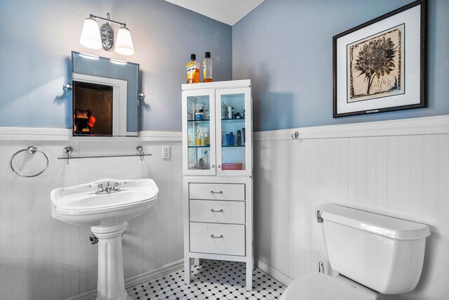 bathroom featuring tile flooring and toilet