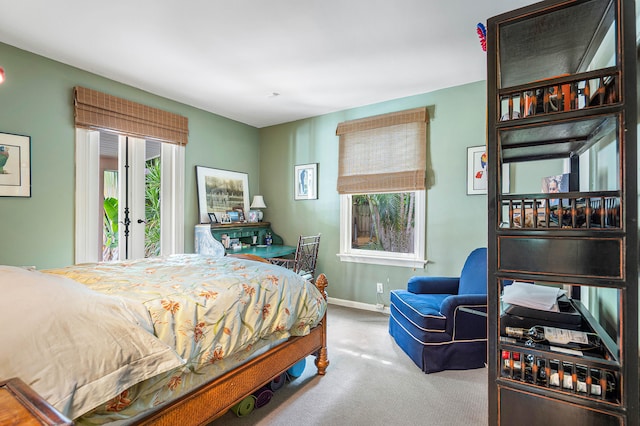 carpeted bedroom featuring french doors and access to outside