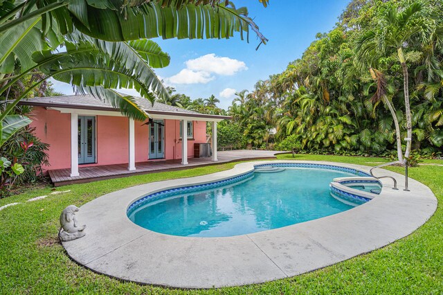 view of pool with a yard, central AC, and a patio area