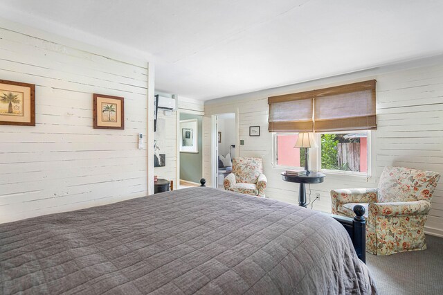 bedroom featuring carpet flooring and an AC wall unit