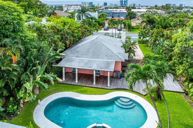 view of pool with a yard