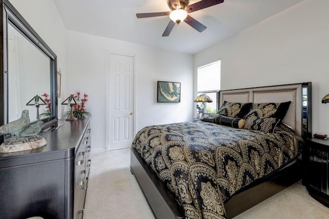 bedroom with ceiling fan and light colored carpet