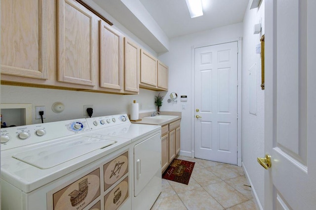 laundry area with sink, light tile patterned floors, cabinets, and independent washer and dryer