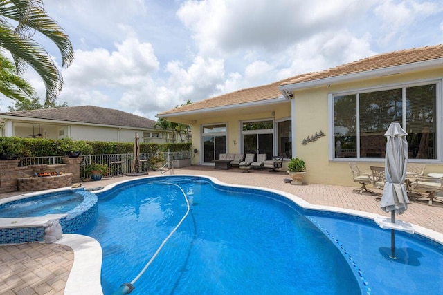 view of swimming pool featuring an in ground hot tub and a patio area