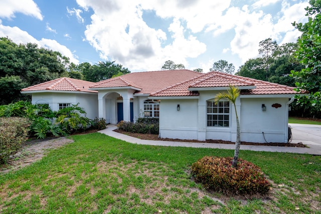 mediterranean / spanish-style house with a front lawn