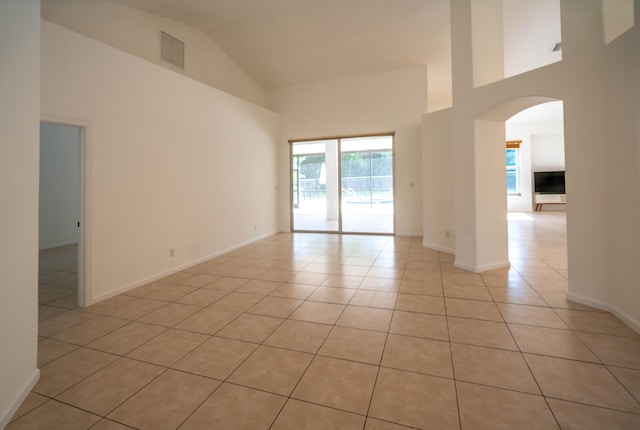 tiled empty room with high vaulted ceiling