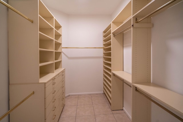 walk in closet featuring light tile flooring