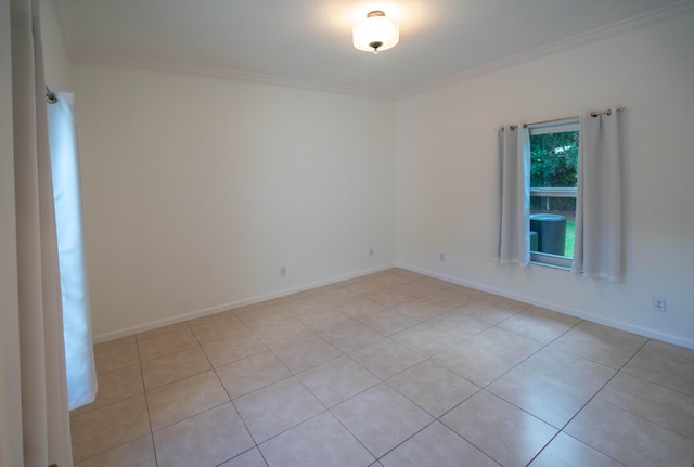 tiled spare room with crown molding