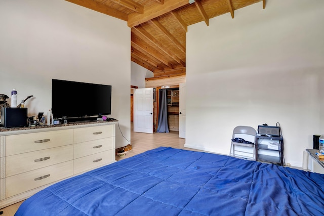 bedroom with wood ceiling, light hardwood / wood-style flooring, and lofted ceiling with beams