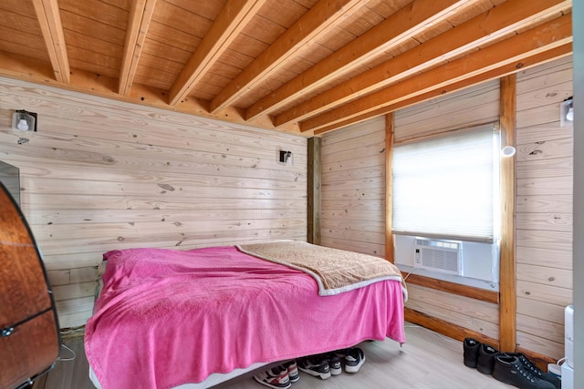 bedroom with cooling unit, hardwood / wood-style floors, and wood walls