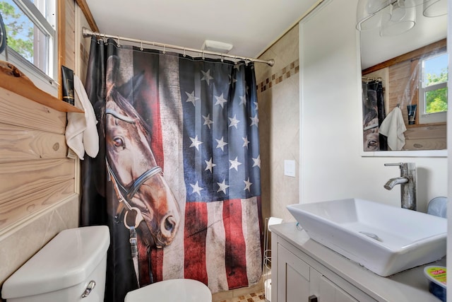 bathroom with vanity, toilet, and curtained shower