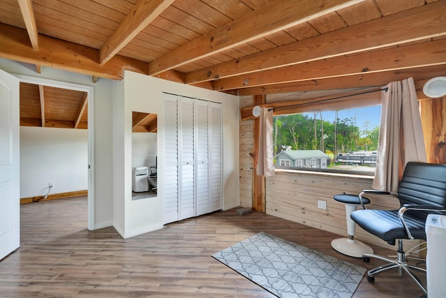 sitting room featuring beamed ceiling, wood walls, hardwood / wood-style flooring, and wooden ceiling